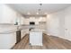 Modern kitchen with white cabinets, granite countertops, and stainless steel appliances at 138 New Twin Branch Ct, Smithfield, NC 27577