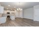 Open kitchen with a kitchen island, hardwood floors and white cabinets and stainless steel appliances at 138 New Twin Branch Ct, Smithfield, NC 27577