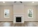 Bright living room with a fireplace, and windows providing natural light with hardwood floors at 138 New Twin Branch Ct, Smithfield, NC 27577