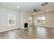 Open living room featuring a fireplace, ceiling fan and windows bringing in natural light at 138 New Twin Branch Ct, Smithfield, NC 27577