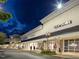 Outlet shopping center with popular brand stores, streetlights, and pedestrian walkway at night at 138 New Twin Branch Ct, Smithfield, NC 27577