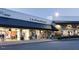 Under Armour and Loft stores with pedestrian traffic in an outdoor shopping center at 138 New Twin Branch Ct, Smithfield, NC 27577