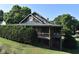 Exterior view of a quaint theater with rustic log cabin design and lush landscaping at 138 New Twin Branch Ct, Smithfield, NC 27577