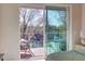 Charming bedroom with balcony access offering views of the surrounding neighborhood and lush greenery at 600 N Roxboro St # 24, Durham, NC 27701