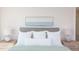 Bright bedroom featuring calming artwork and plush pillows at 600 N Roxboro St # 24, Durham, NC 27701