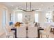 Dining area featuring a modern chandelier, table set for six, and an open layout to the living and kitchen areas at 600 N Roxboro St # 24, Durham, NC 27701