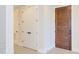 Bright hallway showcasing modern white doors and a contrasting dark wood door accentuating interior design at 600 N Roxboro St # 24, Durham, NC 27701