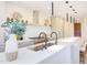 Spacious kitchen with a long island featuring modern fixtures, stainless steel appliances, and a view to the dining area at 600 N Roxboro St # 24, Durham, NC 27701
