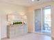 Light and airy room with modern dresser, lamps, and glass door to outdoor balcony with seating at 600 N Roxboro St # 24, Durham, NC 27701