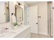Well-lit bathroom featuring a double vanity with modern fixtures, sleek mirrors, and a walk-in shower at 600 N Roxboro St # 43, Durham, NC 27701