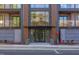 Modern building entrance with glass doors and wood accents, complemented by manicured landscaping at 600 N Roxboro St # 43, Durham, NC 27701