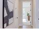 Hallway leading to a bedroom, accentuated with modern artwork and natural light streaming through the doorway at 600 N Roxboro St # 43, Durham, NC 27701