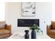 Inviting living room with a modern fireplace, two leather armchairs and travertine coffee table at 600 N Roxboro St # 43, Durham, NC 27701