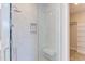 Modern shower with a glass door, marble tile, built in soap shelves, and shower seat at 600 N Roxboro St # 43, Durham, NC 27701