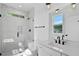 Bright bathroom with a glass enclosed shower, modern vanity, and a window at 2329 E Main St, Durham, NC 27703