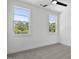 Cozy bedroom featuring natural light from two windows and neutral carpet at 2329 E Main St, Durham, NC 27703