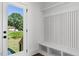 Well-lit entryway featuring shiplap wall accents, convenient bench seating, and a glass door to the exterior at 2329 E Main St, Durham, NC 27703