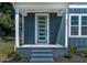 Charming home with a covered front porch, blue siding, and a modern front door with a sidelight at 2329 E Main St, Durham, NC 27703