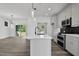 Open-concept kitchen features a large island, modern lighting, and seamless flow to the living area at 2329 E Main St, Durham, NC 27703