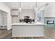 Modern kitchen with large island, stylish pendant lights, stainless steel appliances, and gray backsplash at 2329 E Main St, Durham, NC 27703