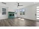 Bright living room with a modern ceiling fan, wood floors, and a stylish fireplace at 2329 E Main St, Durham, NC 27703