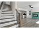 Open-concept layout with staircase and living area featuring a tile fireplace and an adjacent kitchen at 2329 E Main St, Durham, NC 27703