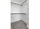 Bright walk-in closet with carpet and built-in shelving and closet rods at 2329 E Main St, Durham, NC 27703
