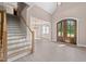 Inviting entryway features a staircase, light hardwood floors, and a front door with glass panels at 4268 Jacks Creek Trl, Burlington, NC 27215