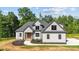 New construction home with gray and white exterior, dark roof, and manicured front yard at 4268 Jacks Creek Trl, Burlington, NC 27215