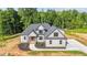 New construction home with gray and white exterior, dark roof, and manicured front yard at 4268 Jacks Creek Trl, Burlington, NC 27215
