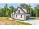 The home features a side entry garage with a paved driveway and professional landscaping at 4268 Jacks Creek Trl, Burlington, NC 27215