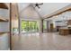 Open-concept living room boasts a vaulted ceiling, wood beams, fireplace, and access to the outdoor deck at 4268 Jacks Creek Trl, Burlington, NC 27215