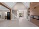Spacious living room with a staircase, fireplace, wood beams, and light hardwood floors at 4268 Jacks Creek Trl, Burlington, NC 27215