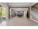 Open-concept living room showcases wood beams, access to a deck, and a glimpse into the kitchen at 4268 Jacks Creek Trl, Burlington, NC 27215