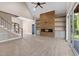 Living room with a vaulted ceiling, modern fireplace, and access to the outdoor deck at 4268 Jacks Creek Trl, Burlington, NC 27215