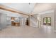 Open-concept living room with wood beams, access to the kitchen, neutral paint, and light hardwood floors at 4268 Jacks Creek Trl, Burlington, NC 27215