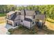 Rear view of the home, featuring gray siding, a covered back porch, and a two-car garage at 4268 Jacks Creek Trl, Burlington, NC 27215