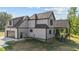 Rear exterior view of home with gray siding and a covered back porch with stairs at 4268 Jacks Creek Trl, Burlington, NC 27215