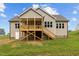 Exterior view of backyard with elevated porch, stairs and siding at 75 Woodbark Cv # 10, Willow Springs, NC 27592