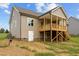 Exterior side view of house with porch, siding, stairs, and a white door at 75 Woodbark Cv # 10, Willow Springs, NC 27592