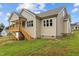 Rear view of home with a covered back porch and wooden stairs to the yard at 75 Woodbark Cv # 10, Willow Springs, NC 27592