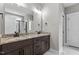 Bathroom with a granite countertop, double sinks, a large mirror, and a tiled shower at 75 Woodbark Cv # 10, Willow Springs, NC 27592