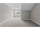 Neutral bedroom with new carpet, light gray walls and a view of the lake at 75 Woodbark Cv # 10, Willow Springs, NC 27592