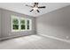 Bright bedroom featuring a ceiling fan and large windows offering ample natural light at 75 Woodbark Cv # 10, Willow Springs, NC 27592