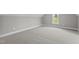 Bright, carpeted bedroom with a large window and neutral walls at 75 Woodbark Cv # 10, Willow Springs, NC 27592