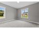 Bedroom with natural light and two large windows at 75 Woodbark Cv # 10, Willow Springs, NC 27592
