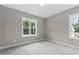Bedroom filled with natural light from large windows and neutral walls at 75 Woodbark Cv # 10, Willow Springs, NC 27592