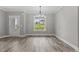 Dining room featuring hardwood floors, grey walls, and large windows with a view at 75 Woodbark Cv # 10, Willow Springs, NC 27592