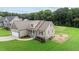 Exterior of charming two-story home featuring manicured lawn, attached garage, and neutral siding at 75 Woodbark Cv # 10, Willow Springs, NC 27592