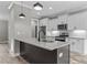 Modern kitchen island with pendant lighting and white cabinetry at 75 Woodbark Cv # 10, Willow Springs, NC 27592